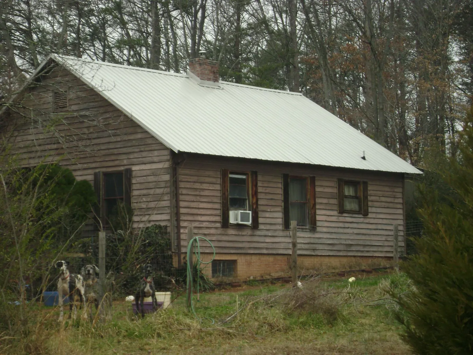 White metal roof on an old wood sided farmhouse, from a Metal Roof Installation job in Mount Victory